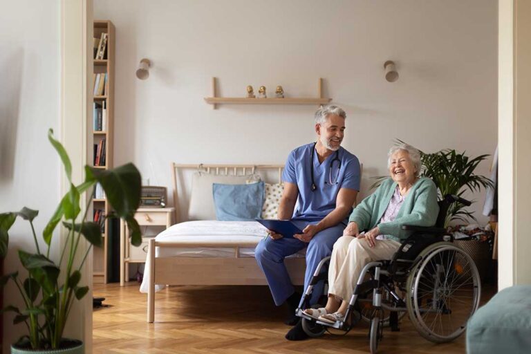 Older adult and family member review care options with a staff member in a bright assisted living common room.